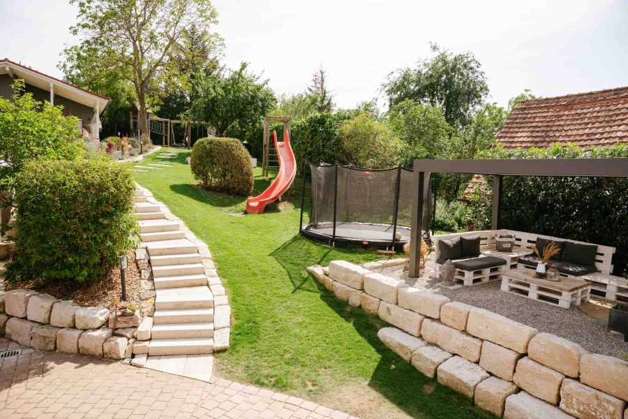 View of the sunny garden with children's playground