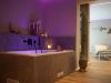 Young woman relaxing in a whirlpool bathtub in the spa area of ​​the holiday farm